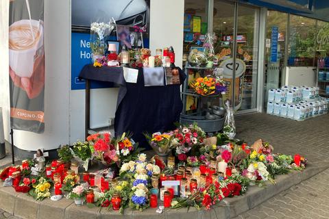 Blumen und Kerzen sind vor einer Tankstelle aufgestellt. Ein Angestellter der Tankstelle war am Samstagabend von einem mit einer Pistole bewaffneten Mann erschossen worden.  Foto: dpaBirgit Reichert